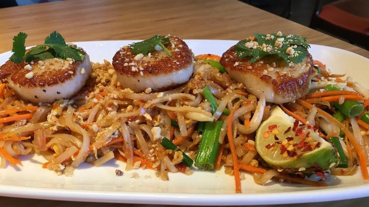 Seared jumbo sea scallops atop pad thai at Malai Kitchen were perfectly cooked, and the dish had nicely contrasting textures.
