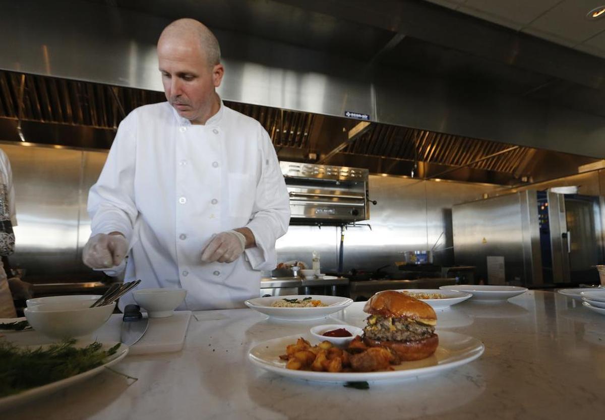 Chef Jeff Williams plates an order at the Taste Community Restaurant in Fort Worth. Williams said his parents occasionally skipped meals during tough times so he and his sister could eat.