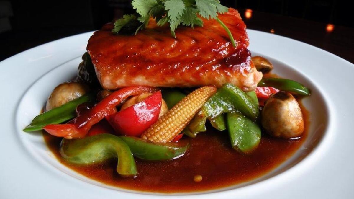 Eastern salmon (pan-seared salmon served on top of bell pepper, snow peas, baby corn, mushroom and sweet chili tamarind sauce) from Zenna Restaurant, due to open a Fort Worth location in early 2018