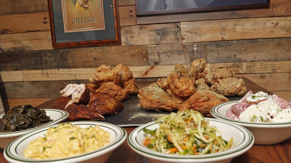 Greens, grits, slaw and potato salad cozy up next to piles of fried and smoked chicken at Prohibition Chicken in Lewisville.