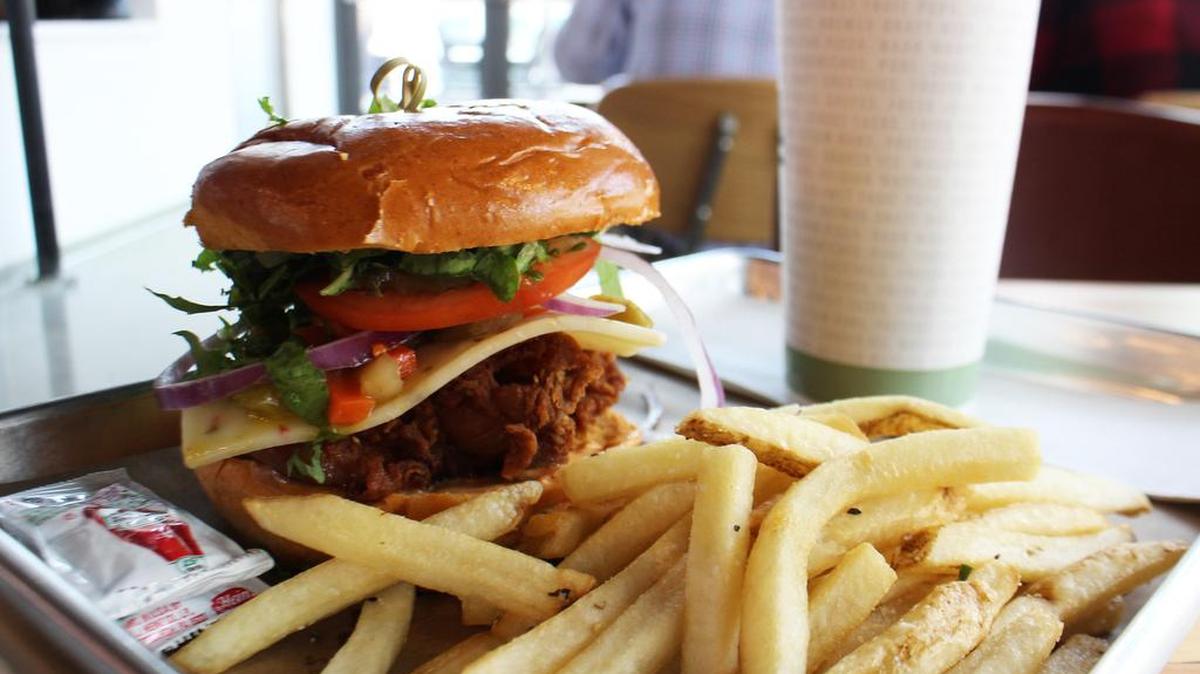 The “Spicy Bird” (fried chicken with kimchi mayo, Mozzarella Co. hot caciotta cheese and seasonal pickles) with duck fat fries from Roots Chicken Shak, “Top Chef” alum Tiffany Derry’s food stall at Legacy Hall in Plano