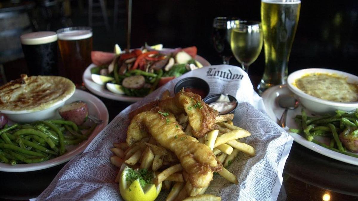 From better days at Sherlock’s Baker St. Pub & Grill in Arlington (clockwise from front; fish and chips, chicken potpie, spinach salad with blackened chicken and shepherd’s pie.