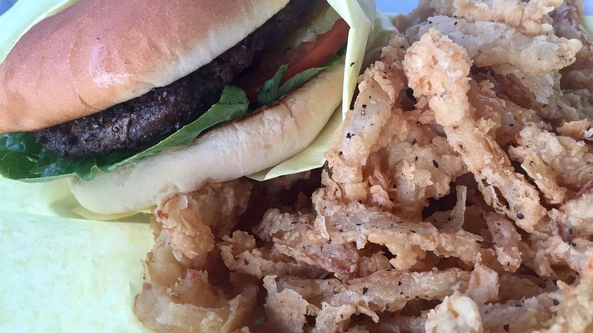 A burger with onion strings at Augie’s Sunset Cafe, in a marina built in 1945.