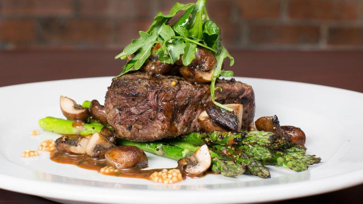 A tenderloin with mushrooms and arugula at Sinclair Restaurant in Clifton.