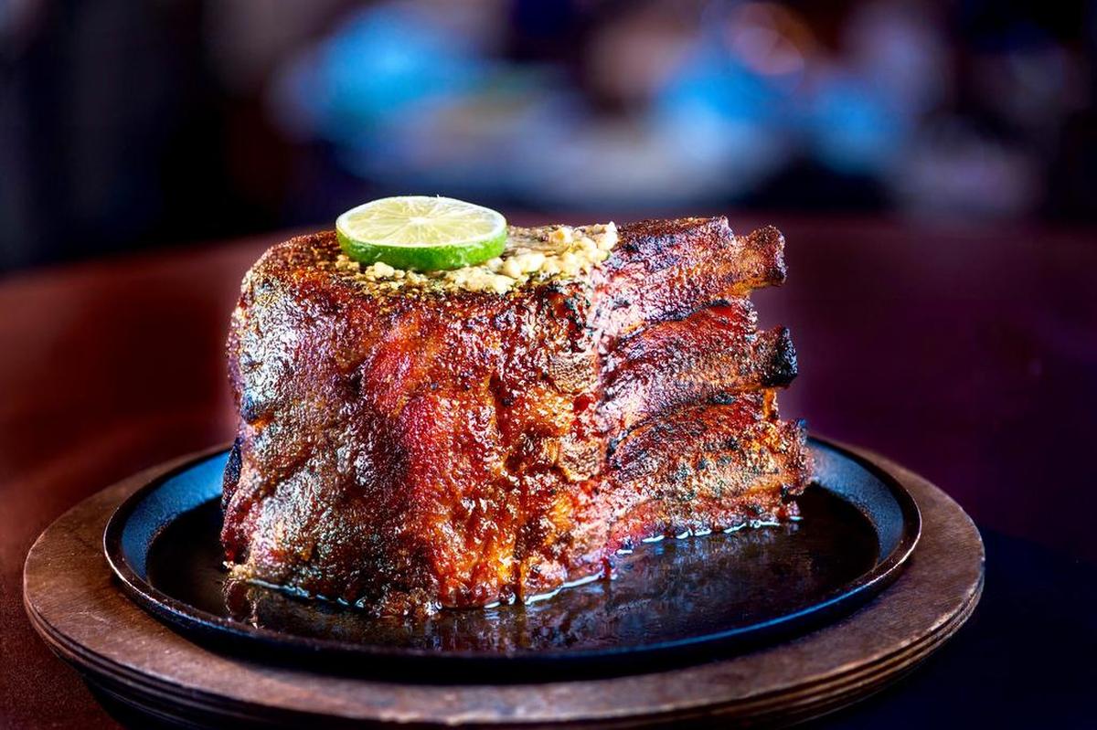 The “seven-finger” pork chop is almost three meals in one at Perry’s Steakhouse & Grille.