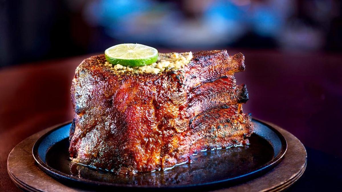 The “seven-finger” pork chop is almost three meals in one at Perry’s Steakhouse & Grille.