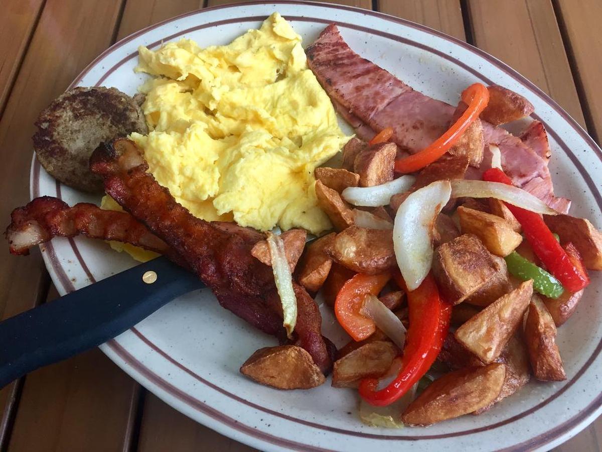 A combo breakfast with ham, bacon. sausage and home fries (and biscuits or pancakes) at Our Place in Burleson.