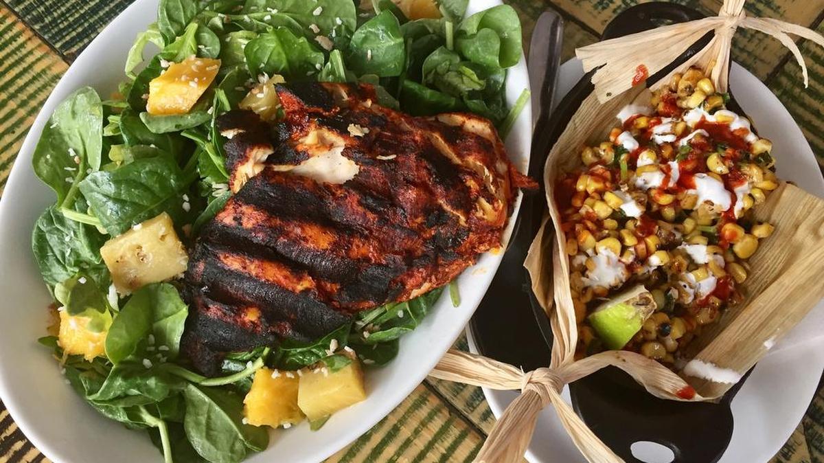 A tropical salad with chipotle chicken plus a roasted-corn side at Wild Salsa, in the One City Place shops in downtown Fort Worth.