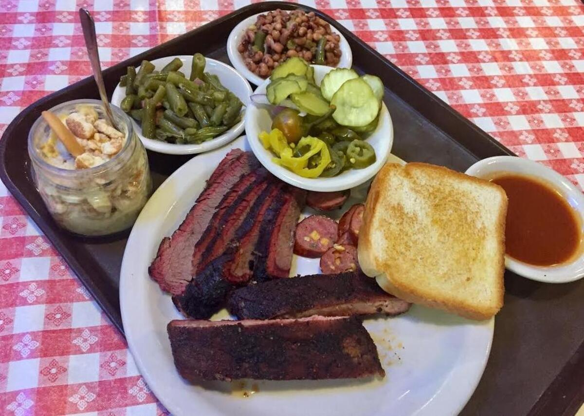 Brisket, ribs, jalapeño sausage, pickles, peppers, green beans, black-eyed peas and banana pudding at Cousins.