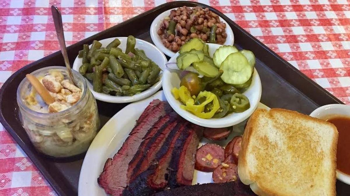 Brisket, ribs, jalapeño sausage, pickles, peppers, green beans, black-eyed peas and banana pudding at Cousins.