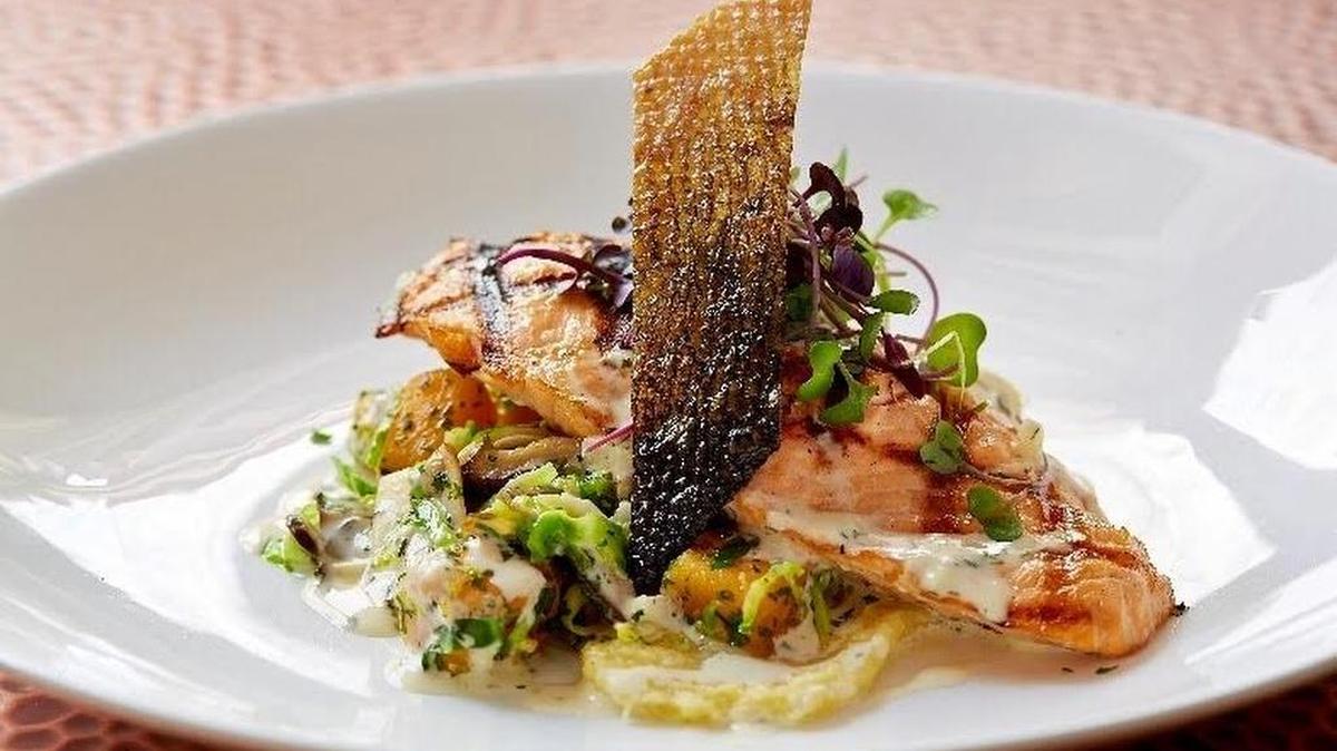 Grilled salmon in a miso-truffle cream sauce is one of “Chef Eddy T” Thretipthuangsin’s signature dishes at Sai Fine Asian Bistro in Colleyville.