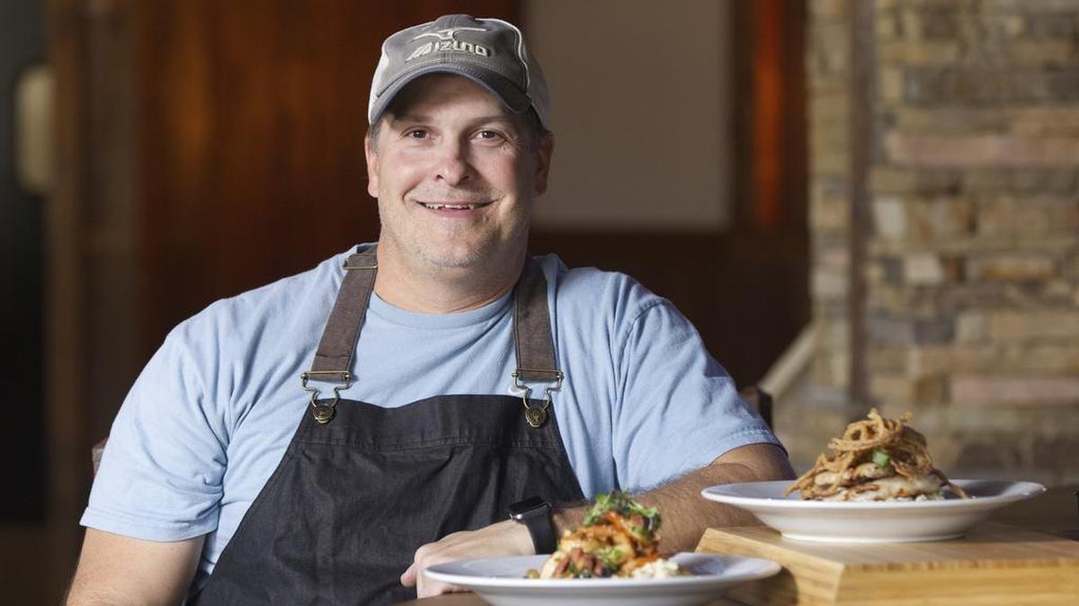 Brian Olenjack posed with his shrimp-and-grits and cider-glazed pork loin at now-closed Eagle Mountain Tavern.