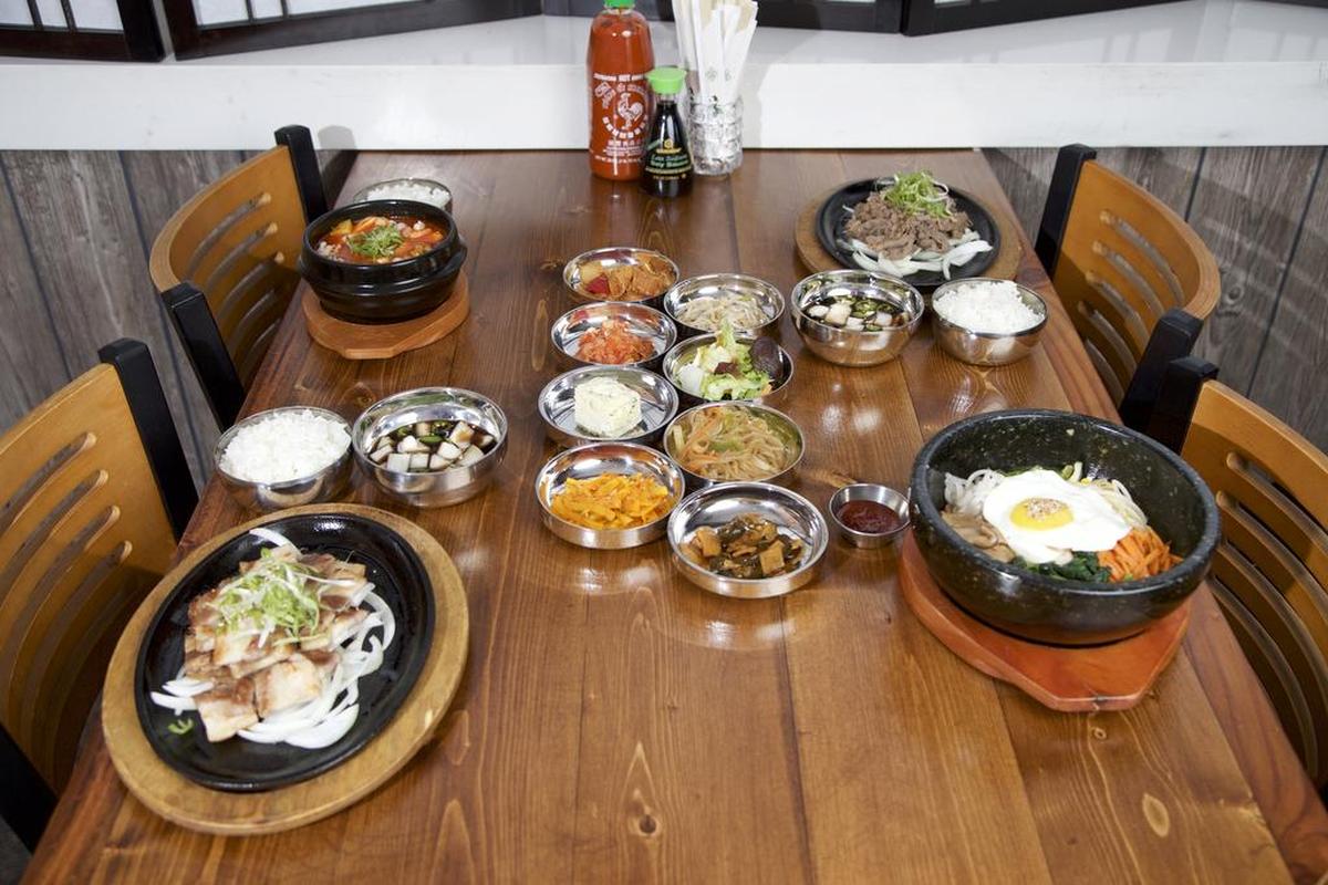 Main entrees clockwise from top left at the revamped Hoya Korean Kitchen in downtown Fort Worth: seafood soon-tufo (seafood soup), samgyupsal (pork belly), dolsot bibimbap (hot stone bowl) and beef bulgogi (marinated beef rib eye) with pan chan (assorted side dishes that change daily).