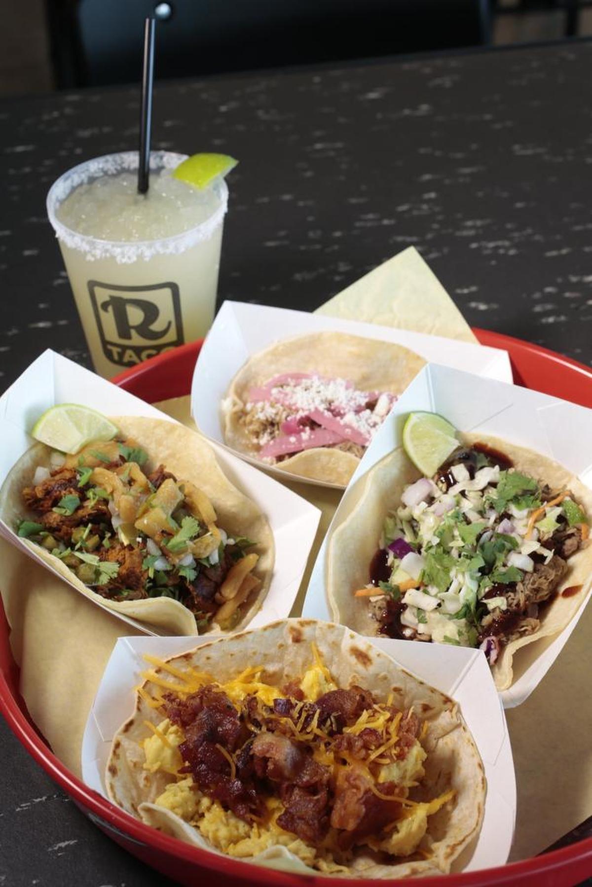 Clockwise from upper right: BBQ brisket taco, bacon-egg-cheese taco, Rusty taco (achiote pork with pineapple, onion and cilantro), roasted pork taco, margarita on the rocks at Rusty Taco.
