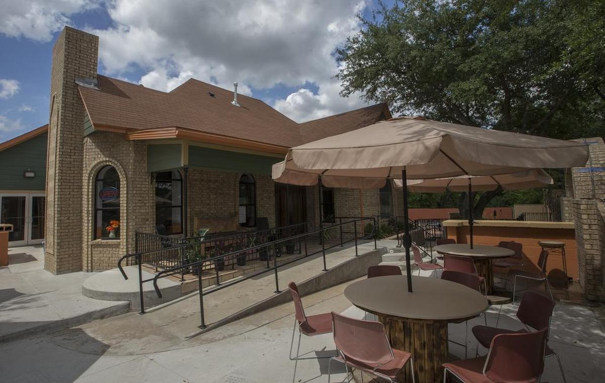 The 130-year-old house is surrounded by a patio, as seen May 22, 2017.