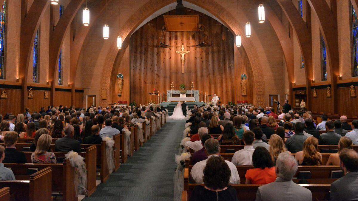 The couple married at a 2pm Nuptial Mass at St. Maria Goretti Church in Arlington.