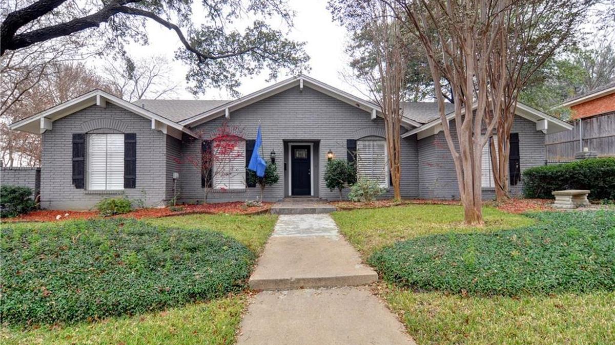 The home at 6869 Woodstock Road is nestled on a large .308-acre lot.