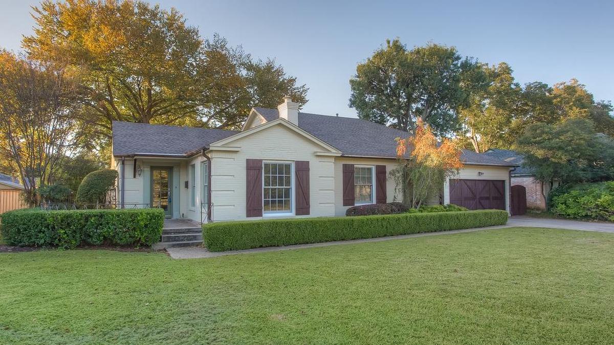 The home at 6127 Locke Avenue features a light-filled living room with original hardwood floors.
