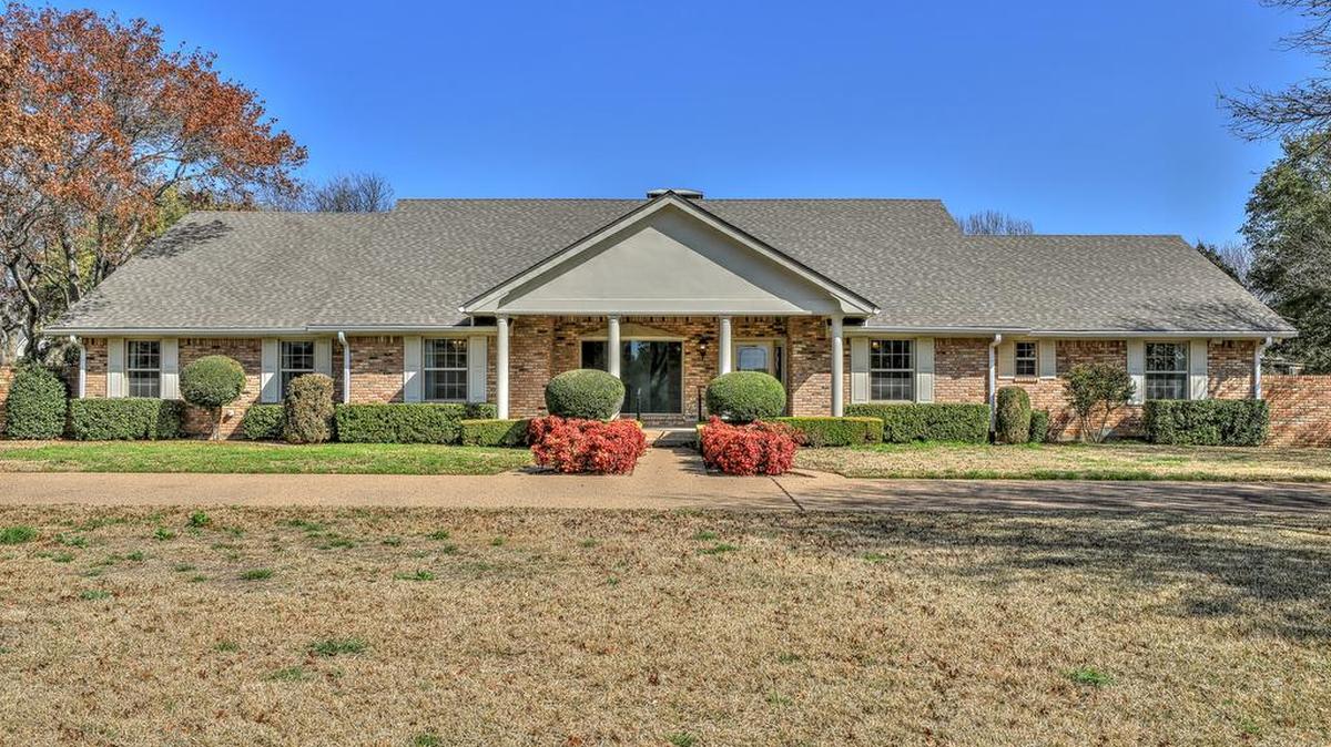 The home at 713 Stonelake Drive is situated on just over an acre of land and on a tree-lined street.
