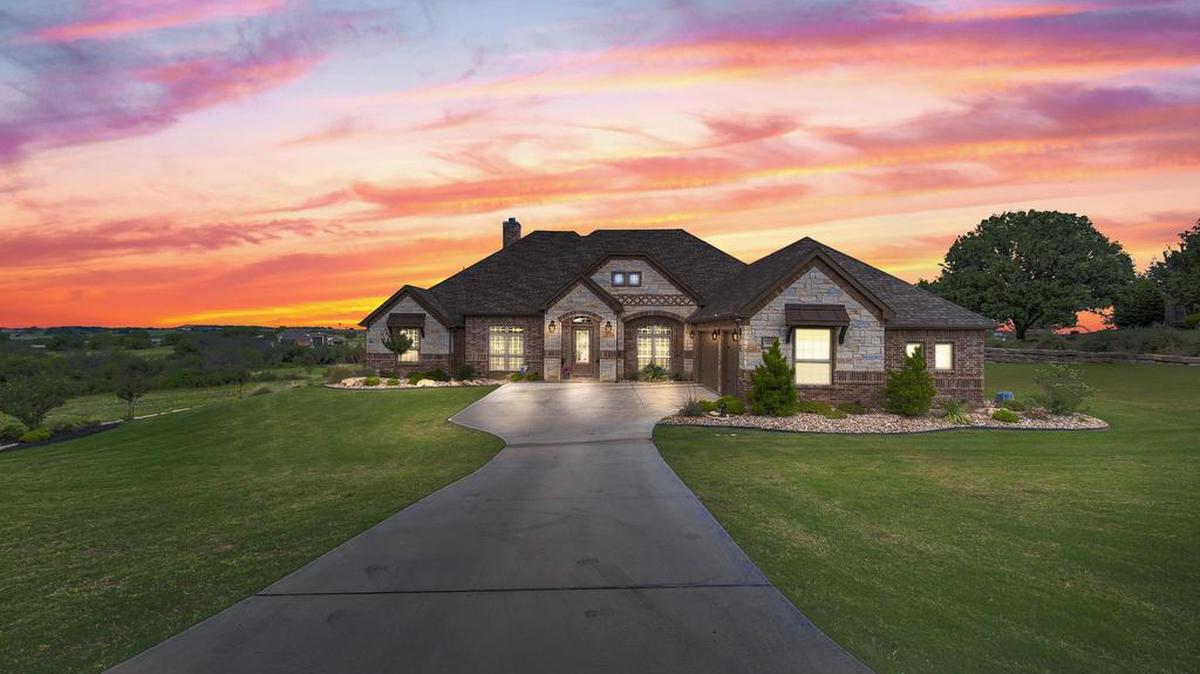 The custom home at 111 Club House Drive sits well situated on a hill with views to the north and west