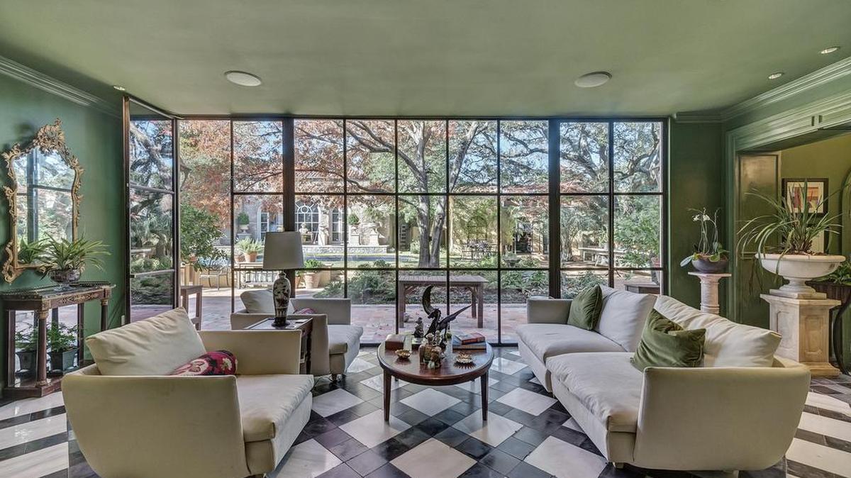 The home at 4104 Clarke Avenue is reached via a private Italian tiled pathway with barreled vines.