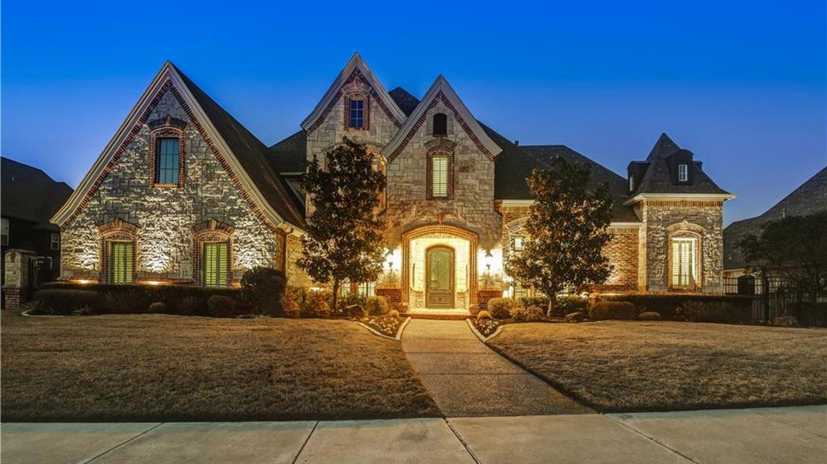 The home at 700 Castle Rock Drive has curb-appeal with brick and stone exterior.