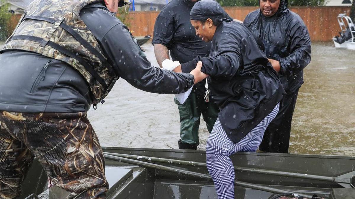 Varias personas son rescatadas de su barrio inundado por el huracán Harvey en Houston. La tormenta arrojó un récord con más de 50 pulgadas de lluvia.