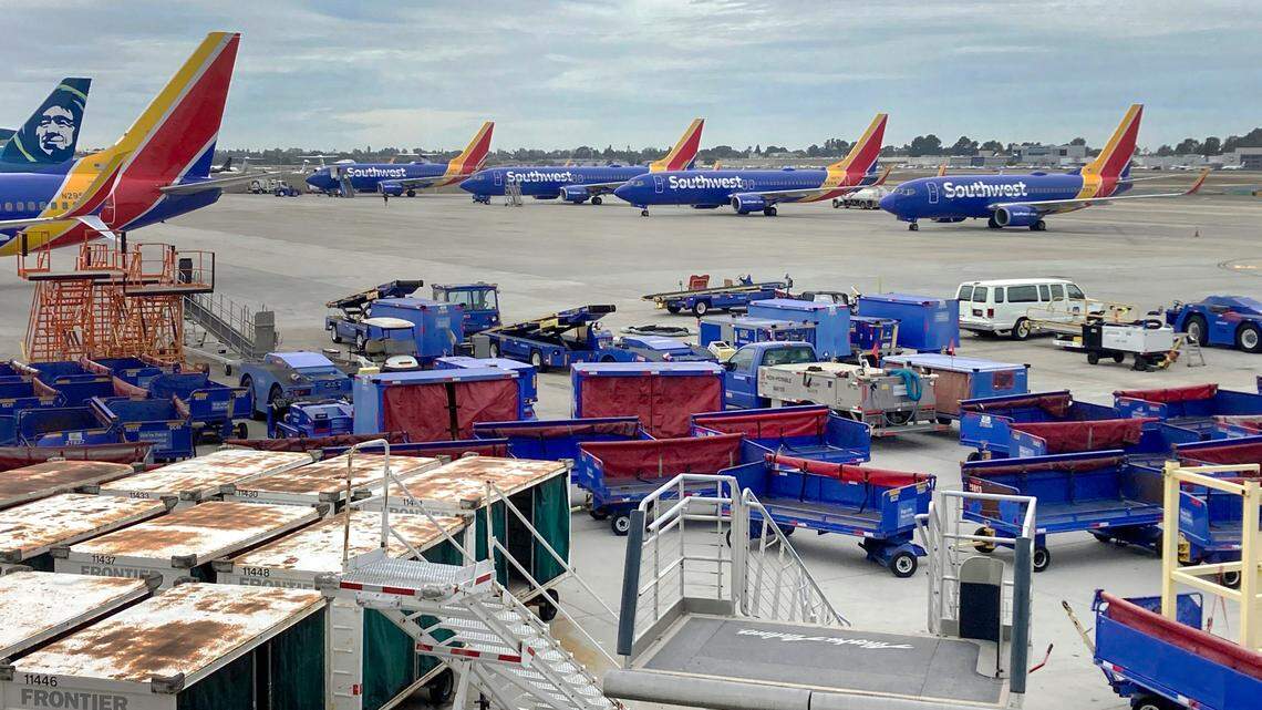 Southwest Airlines jets are seen at the John Wayne Airport in Santa Ana, Calif., on Tuesday as the carrier scrubbed thousands of flights again in the aftermath of the massive winter storm that wrecked Christmas travel plans across the U.S.