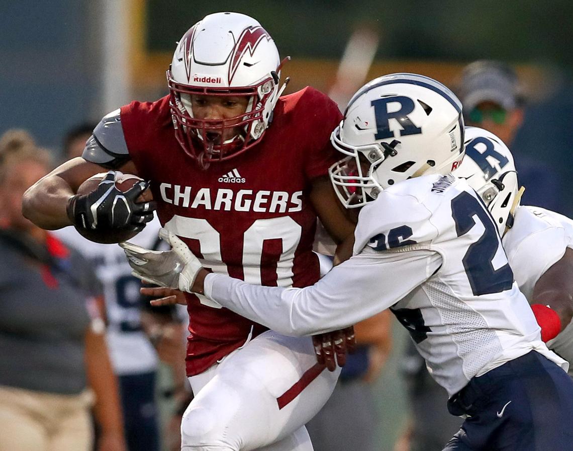 Keller Central running back Andrew Paul (30) tries to get past Richland defensive back Christian Smith-Johnson (26) during the first half, Thursday night, September 5, 2019 played at Keller ISD Stadium in Keller, TX.