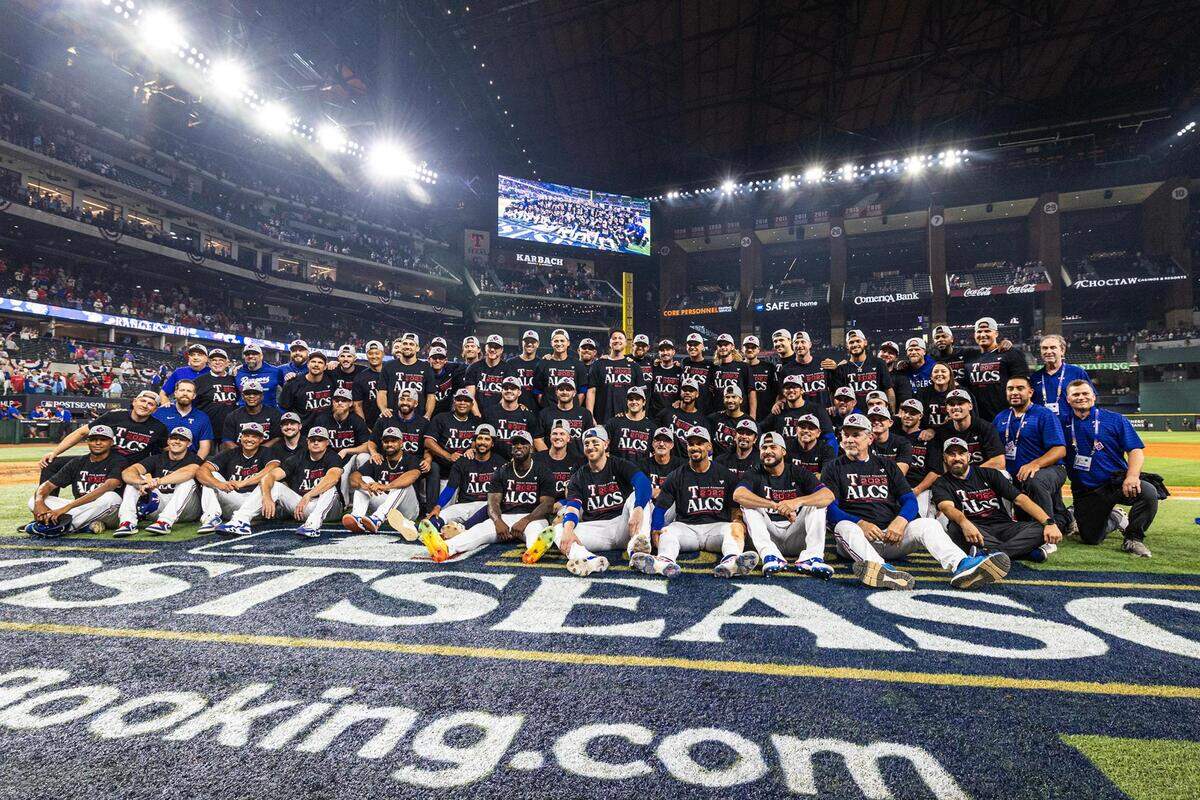 The Texas Rangers gather for a group picture after winning game three to clinch the ALDS between the Texas Rangers and Baltimore Orioles at Globe Life Field in Arlington on Tuesday, Oct. 10, 2023.