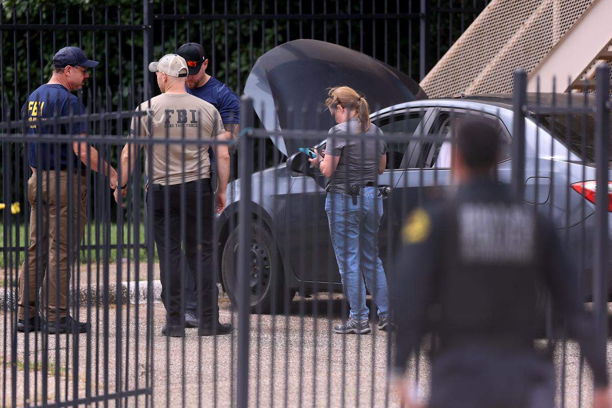 FBI agents investigate the scene where a shooting at an Immigration and Customs Enforcement facility occurred in Dallas on Wednesday, Sept. 24, 2025.
