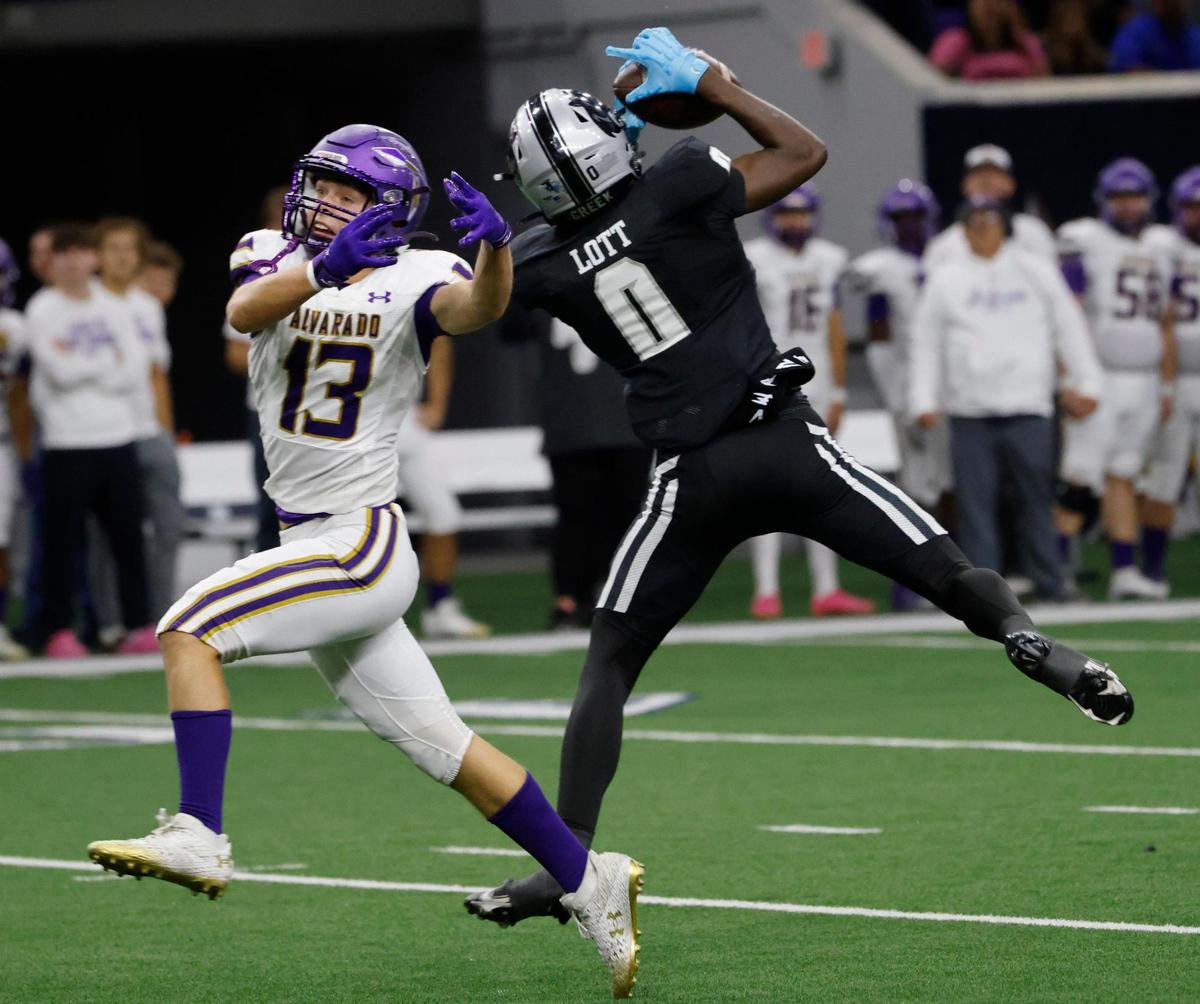 Panther Creek defensive back Jalen Lott (0) intercepts a pass intended for Alvarado wide receiver Logan Bjork (13) during a UIL 4A D1 Area round football playoff game at The Ford Center in Frisco Texas, Thursday, Nov. 21, 2024.