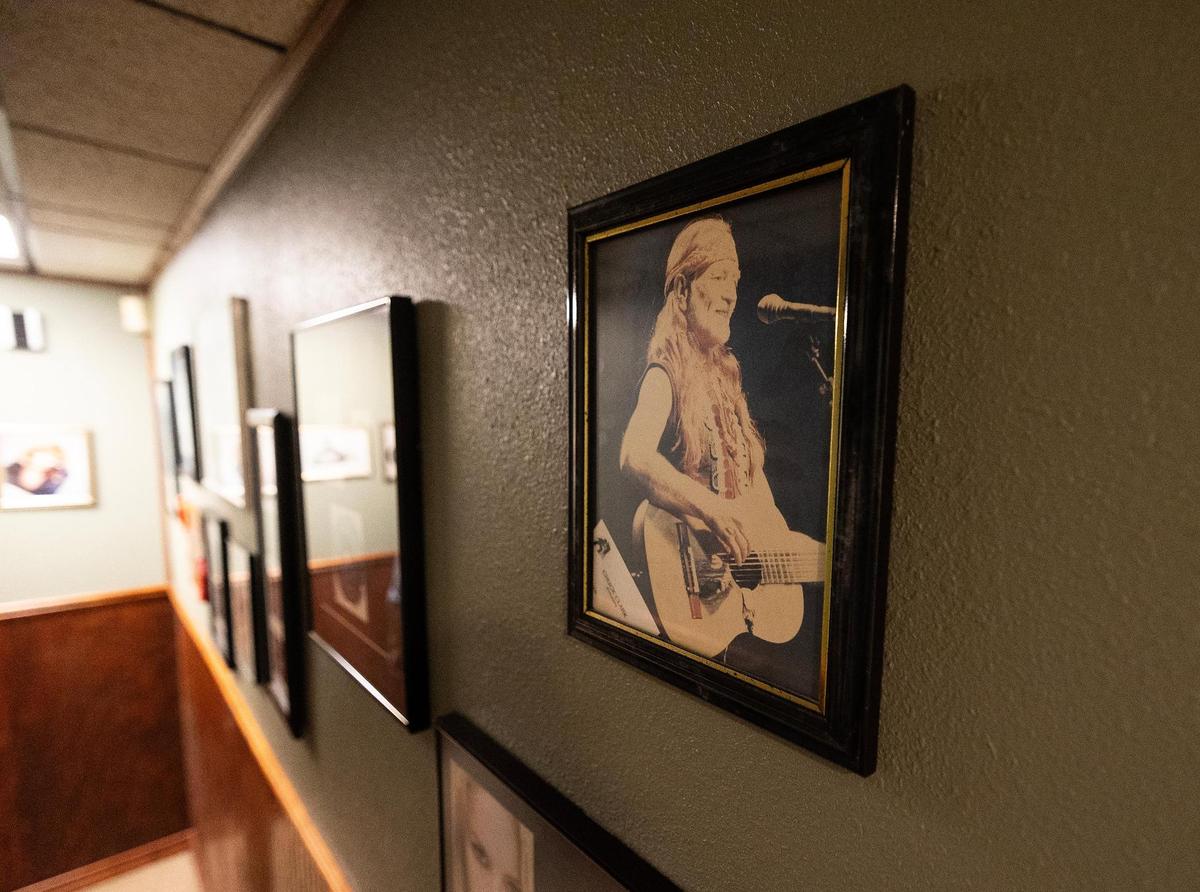A photo of Willie Nelson hangs on the wall with other musicians at Audio Dallas Recording Studio on Thursday, May 8, 2025. Willie Nelson recorded his album‘Red Headed Stranger’ at the studio 50 years ago.