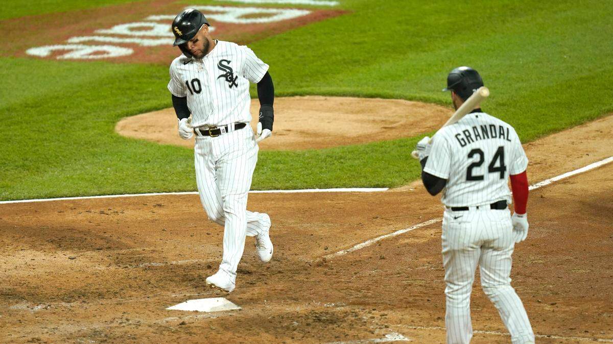 Chicago White Sox’s Yoan Moncada scores on a wild pitch to Yasmani Grandal from Texas Rangers starting pitcher Kyle Gibson during the sixth inning on Saturday, April 24, 2021, in Chicago.