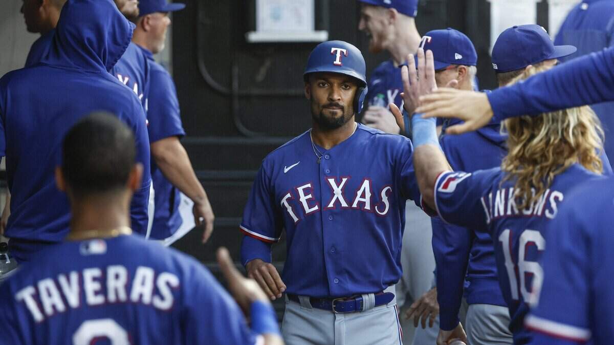 Jun 21, 2023; Chicago, Illinois, USA; Texas Rangers second baseman Marcus Semien (2) celebrates with teammates after scoring against the Chicago White Sox during the third inning at Guaranteed Rate Field. Mandatory Credit: Kamil Krzaczynski-USA TODAY Sports