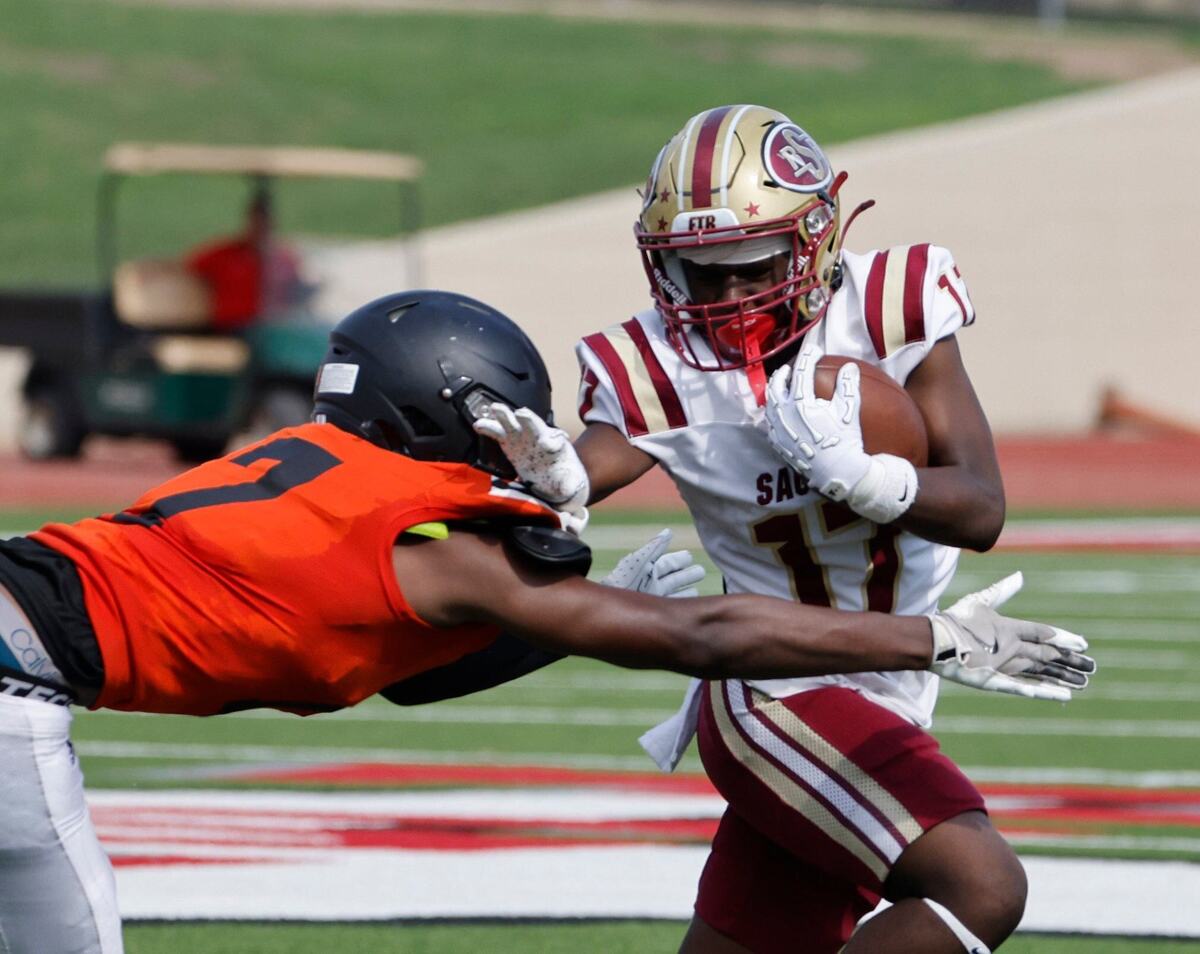 Saginaw wide receiver Boaz Kaloso (17) attempts to avoid the grab of Polytechnic defensive end Anthony Collins (17) during a UIL football game at Farrington Field in Fort Worth Saturday, Sept. 14, 2024.