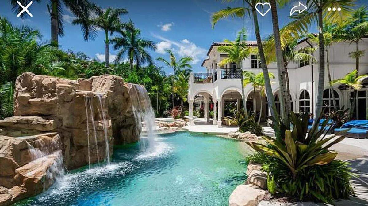 The mega-mansion has a backyard oasis that feels like its own personal retreat