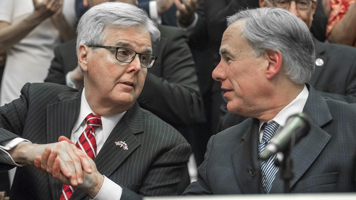 Lieutenant Gov. Dan Patrick, left, shakes hands with Gov. Greg Abbott during a press conference on details of his plan for Texas to build a border wall and provide $250 million in state funds as a “down payment.”, Wednesday, June 16, 2021 in Austin, Texas. (Ricardo B. Brazziell/Austin American-Statesman via AP)