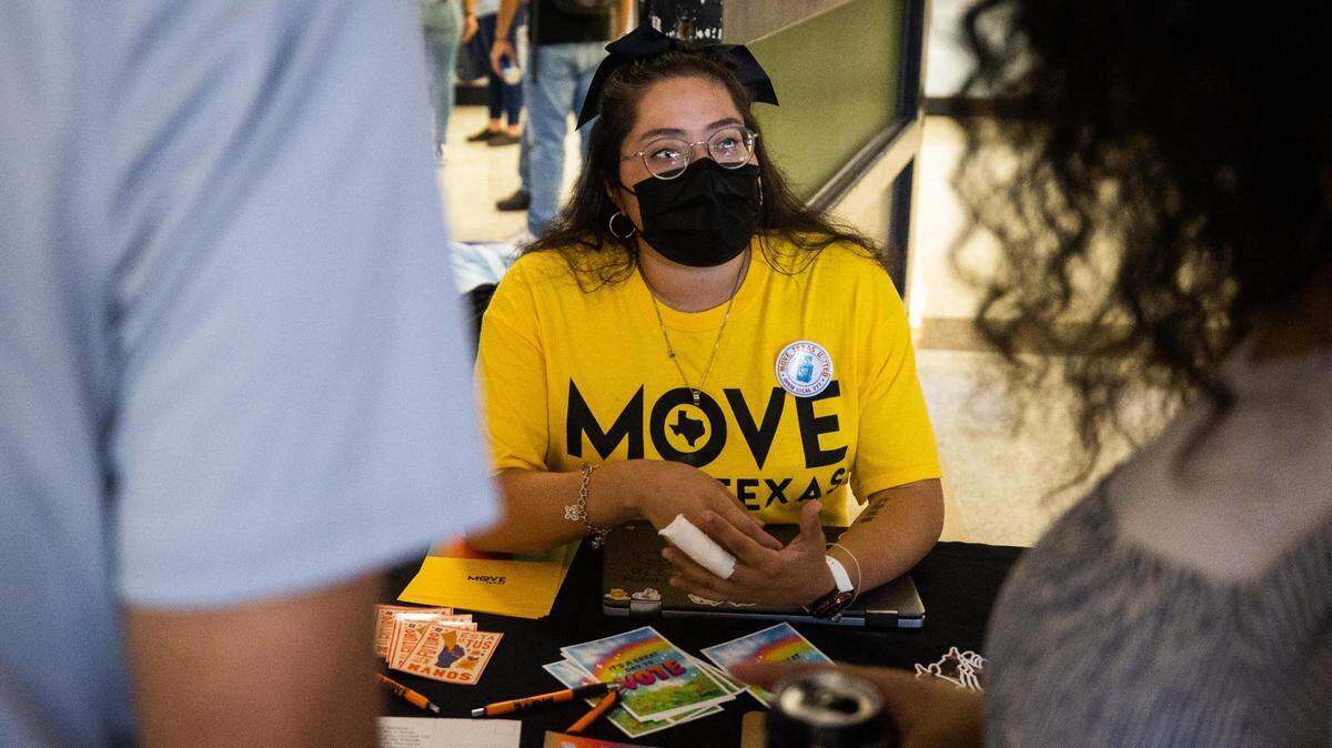 Jazmin Gonzalez, field canvasser with MOVE Texas, chats with students about voter registration during a Spanish Heritage Month event Thursday at the TCC South Campus in Fort Worth. The organization aims to increase participation in elections and voter registration.