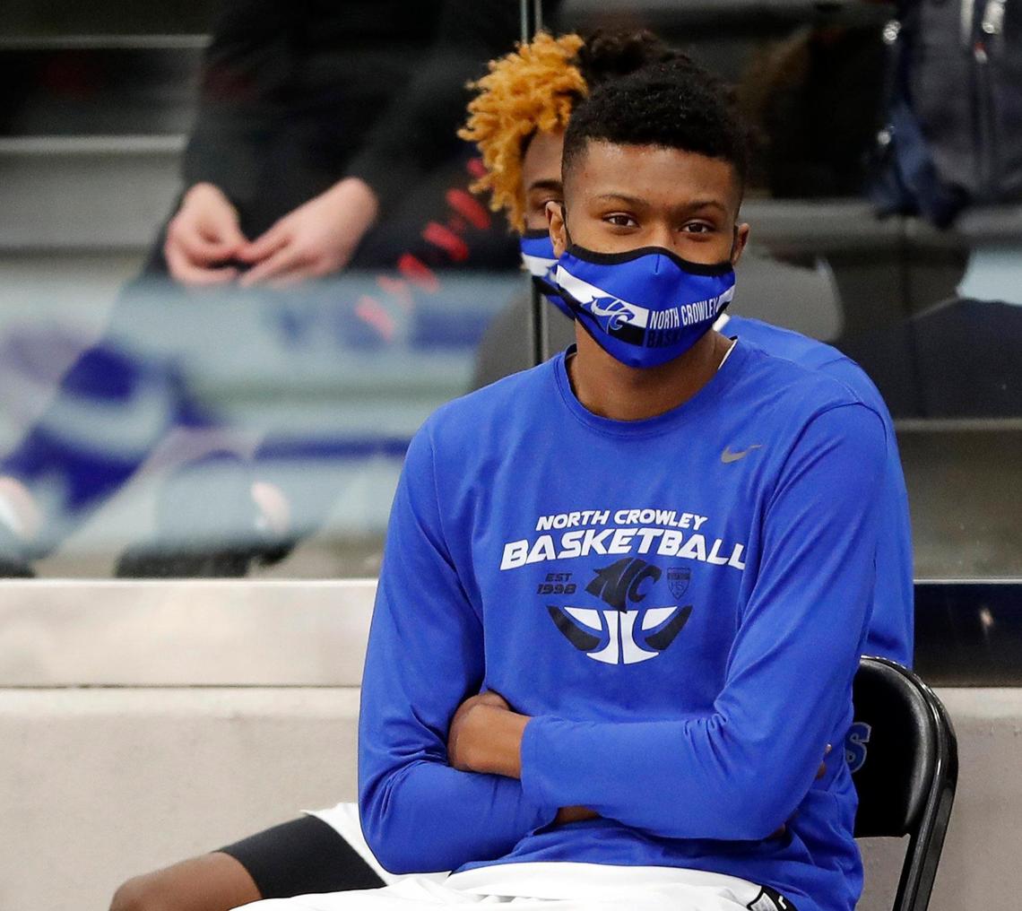 North Crowley forward Mike Hall (21) watches fourth period action in a high school basketball game at North Crowley High School in Crowley, Texas, Tuesday, Jan. 19, 2021. North Crowley defeated Haltom 72-55. (Special to the Star-Telegram Bob Booth)