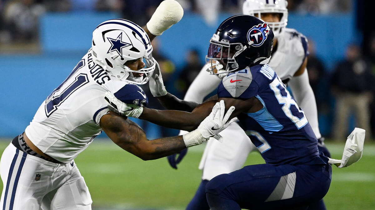 Tennessee Titans tight end Chigoziem Okonkwo (85) blocks Dallas Cowboys linebacker Micah Parsons (11) during their game on Dec. 29 in Nashville.