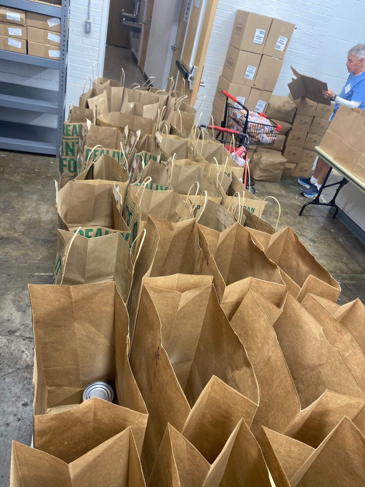 Grocery bags prepped with fresh food and pantry goods for First Presbyterian Church’s Community Crossroads program that provides weekly groceries. Roy Pope Grocery donated over 1,000 pounds of surplus items left after closing on May 31 to become a restaurant.