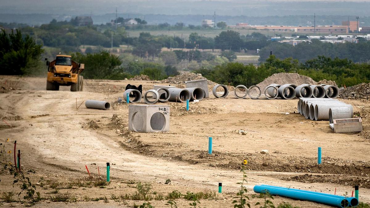 New water lines, storm drainage and other city services are being installed for a new housing development near Chapel Creek Boulevard in west Fort Worth. The city may raise impact fees charged to developers to offset the cost of delivering services to new areas.