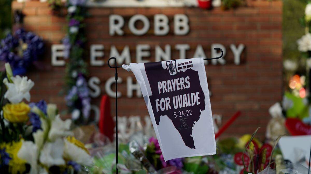 A banner hangs at a memorial outside Robb Elementary School to honor the victims killed in last week’s school shooting, Friday, June 3, 2022, in Uvalde, Texas.