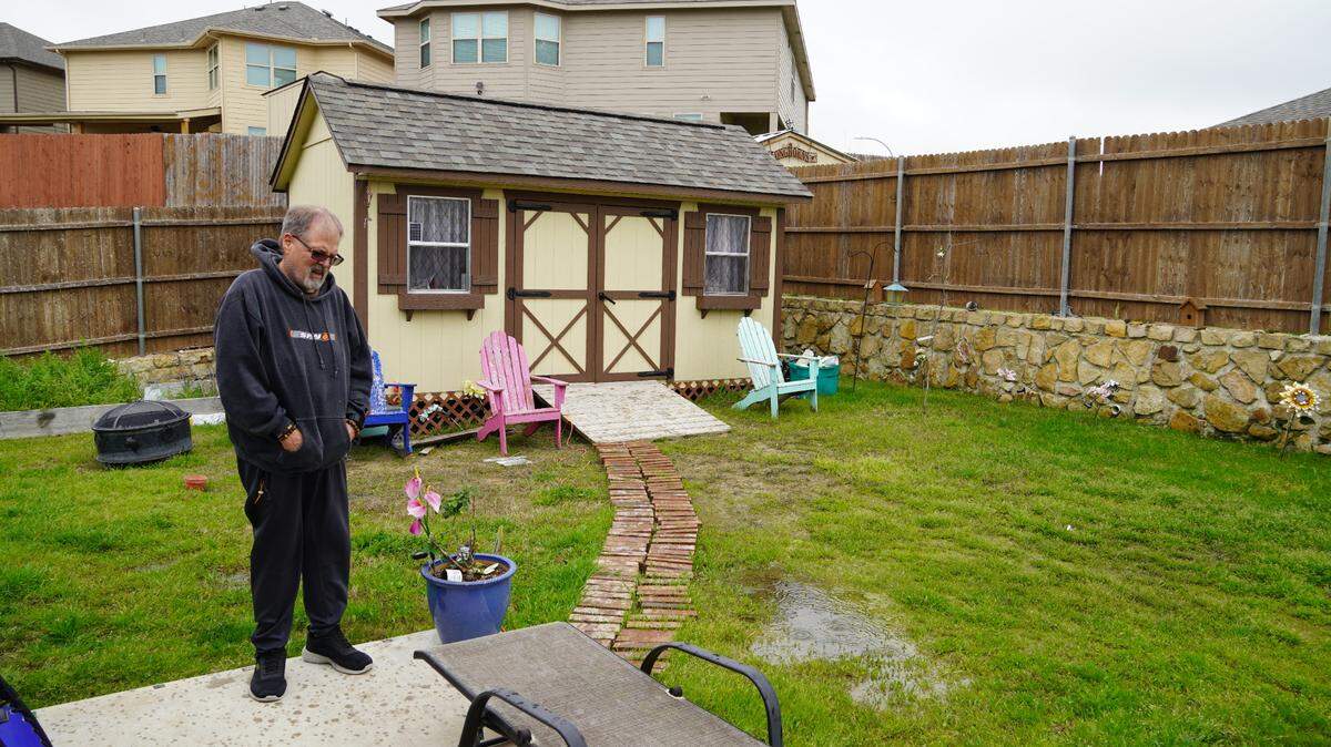 Steve Loftin standing beside a pool of stagnant water in his backyard. He and his wife say they’ve dealt with poor drainage since moving to their west Fort Worth home in 2019.