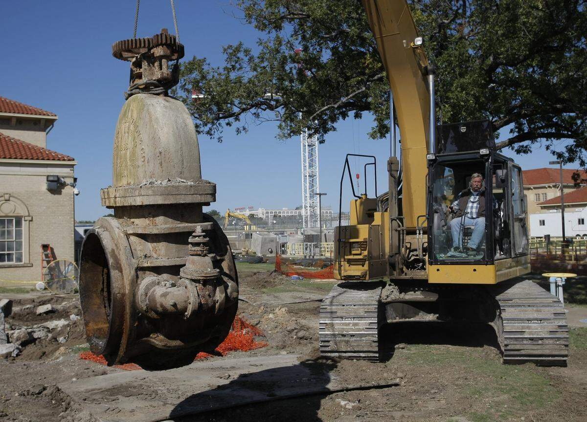In October 2011, a 119-year-old water valve was taken out of service at the North Holly Water Treatment Plant in Fort Worth. Hydraulic excavator operator Dennis Debbert carries a valve after lifting it from its hole.