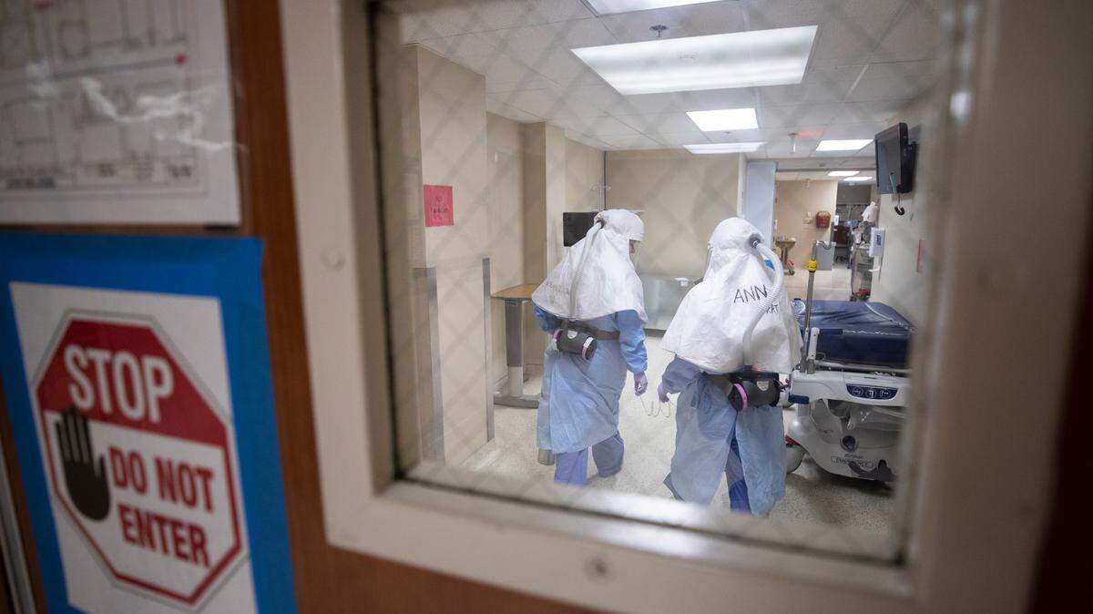 Respiratory therapists work inside the JPS COVID-19 unit.