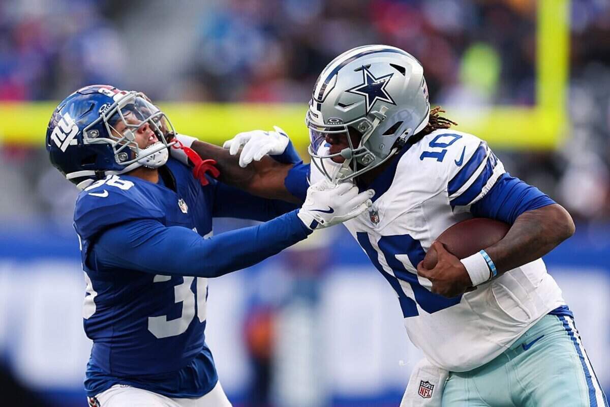 EAST RUTHERFORD, NEW JERSEY - JANUARY 04: Joe Milton III #10 of the Dallas Cowboys runs the ball against Devin Singletary #26 of the New York Giants during the game at MetLife Stadium on January 04, 2026 in East Rutherford, New Jersey. The New York Giants won 34-17. (Photo by Ishika Samant/Getty Images)