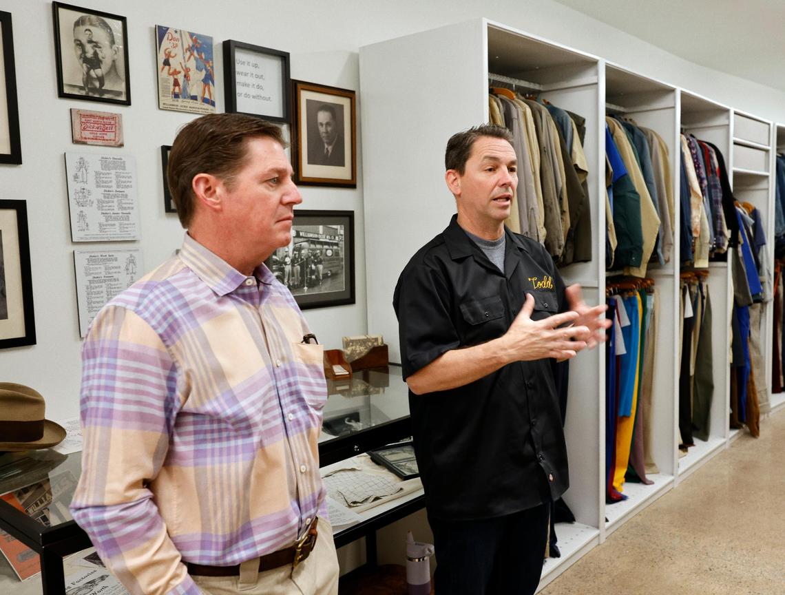 Brand Ambassador Philip Williamson listens as Dickies Global Brand President Todd Dalhausser talks in front of old and used apparel at Dickies offices in downtown Fort Worth Texas, Thursday Mar. 28, 2024. The 102 year old work apparel company recently relocated to downtown Fort Worth. (Special to the Star-Telegram Bob Booth)