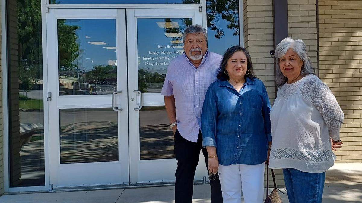 Joe Guerrero, Victoria Bargas, and Laura Tobias Rios stand in front of the Fort Worth Library History Center, previously known as the Seminary South Branch Library. All found the library to be a central point for reading, learning and community.